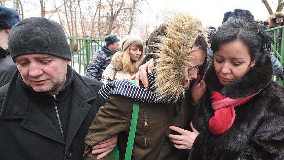 Родители с ребенком возле московской школы №263, в которой старшеклассник устроил стрельбу и захватил заложников