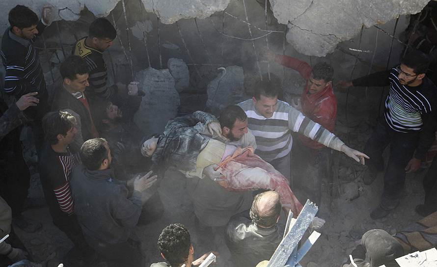 Жители города Алеппо несут тело девушки, вытащенной из-под обломков здания, разрушенного при авиаатаке