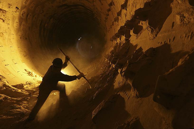 Рабочий чистит вытяжную трубу на цементном заводе в Наджафе, Ирак