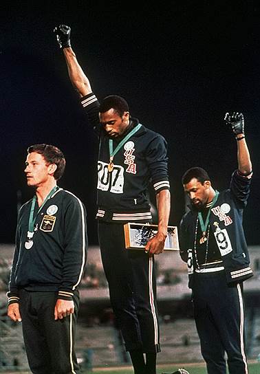 В октябре 1968 года на церемонии награждения на Олимпийских играх в Мехико американские легкоатлеты золотой и бронзовый призеры Игр Томми Смит и Джон Карлос во время исполнения американского гимна опустили головы и подняли сжатые кулаки в черных перчатках, на пресс-конференции заявив о протесте против расизма в США. Оба спортсмена были исключены из команды