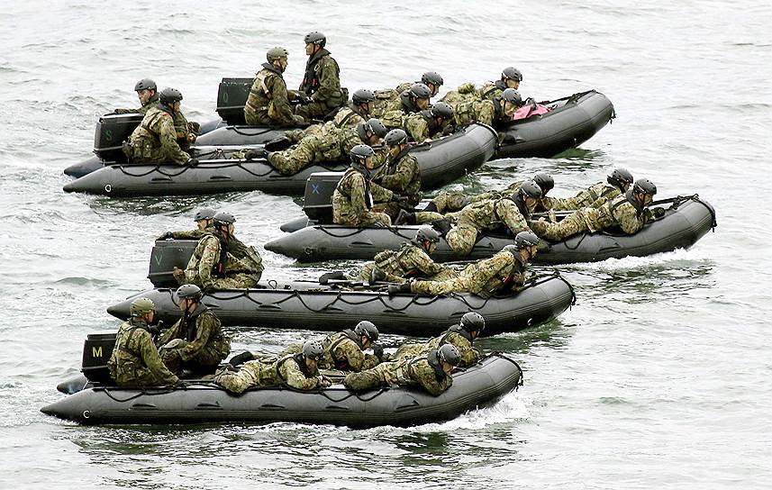 Солдаты сил самообороны Японии плывут на резиновых лодках во время военных учений в районе острова Амами Ошима, префектура Кагосима