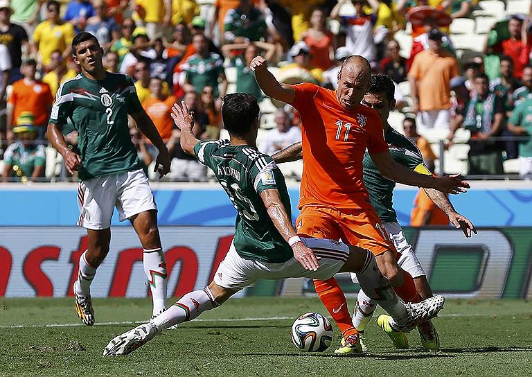 Футболист сборной Нидерландов Арьен Роббен (второй справа) и игроки мексиканской сборной Эктор Морено (слева) и Рафаэль Маркес 