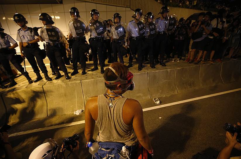 Демонстрант возле полицейского кордона в центре Гонконга