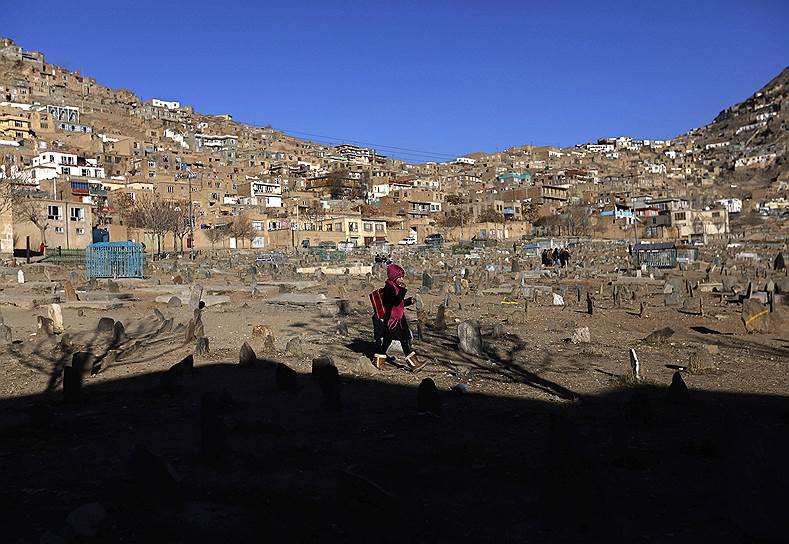 Кабул, Афганистан. Девочка идет через кладбище
