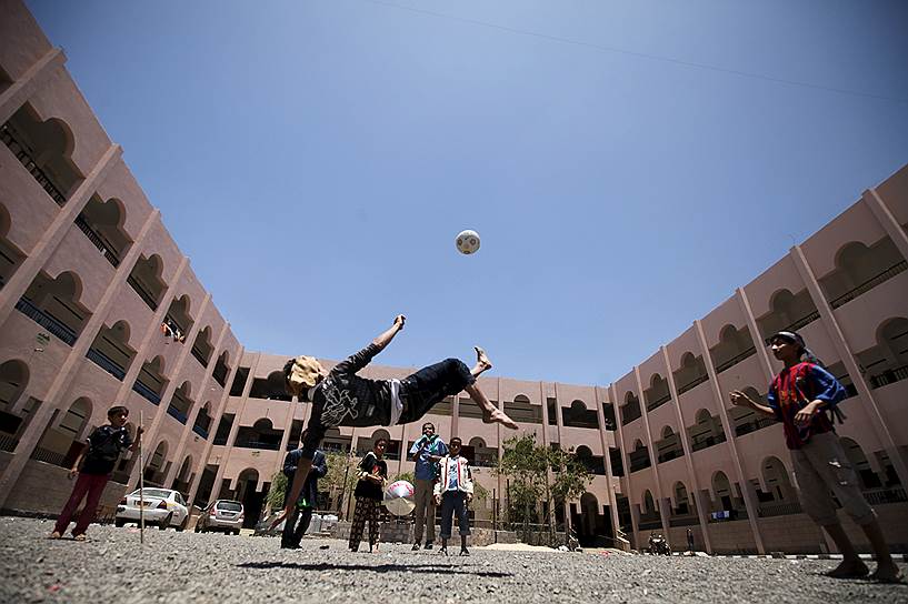 Сана, Йемен. Переселенцы из провинций, где идут боевые действия, играют в футбол на школьном дворе 
