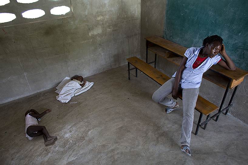 Деревня Фонбайя, Гаити. Шестнадцатилетняя гаитянка Милен Мониме с детьми, депортированная из Доминиканской республики, ждет решения по ее делу в классе местной школы