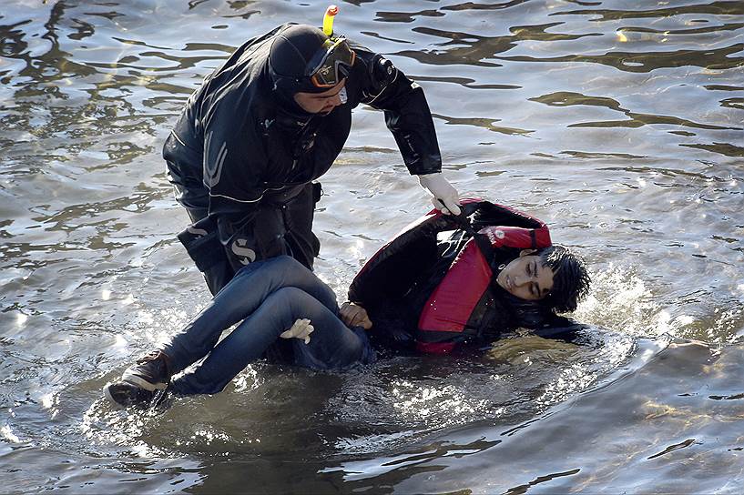 Лесбос, Греция. Спасатель извлекает из воды тело мальчика, погибшего при крушении в море деревянной лодки с семьей мигрантов на борту