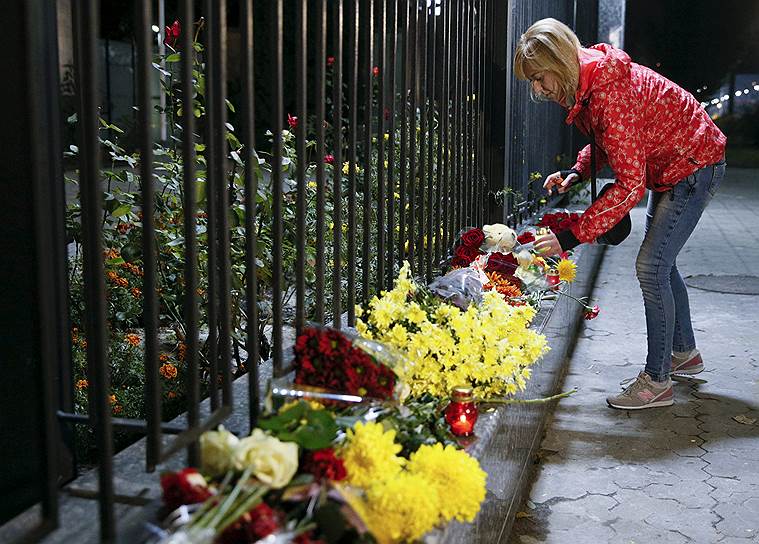 Люди несут цветы к Посольству России в Киеве 