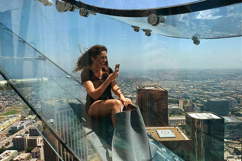 Лос-Анджелес, США. Австралийская журналистка Анжела Кокс делает фотографию на свой телефон на вершине Башни Банка США