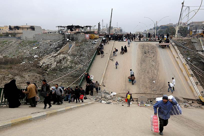 Мосул, Ирак. Беженцы, покидающие город во время операции против террористов «Исламского государства», переходят через мост