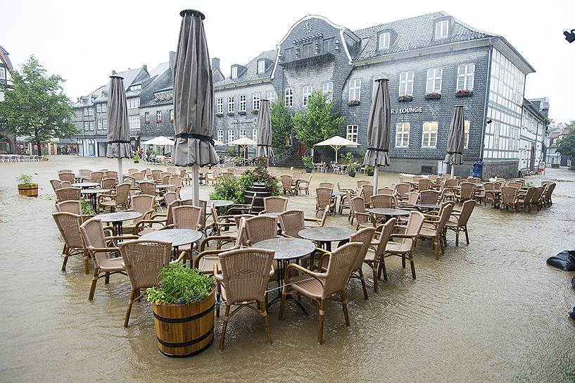 Гослар, Германия. Столы и стулья кафе на затопленной площади