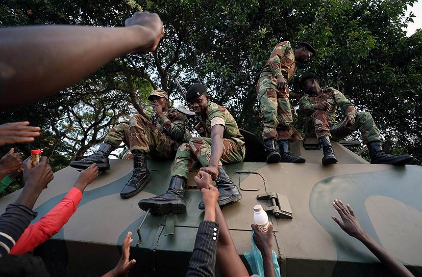 Хараре, Зимбабве. Местные жители празднуют с солдатами отставку президента Роберта Мугабе