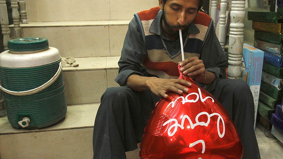 Пешавар, Пакистан. Мужчина надувает воздушный шар в виде сердца в преддверии Дня Святого Валентина