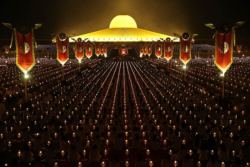 Патхумтхани, Таиланд. Верующие и монахи молятся в храме Ват Пхра Дхаммакая во время праздника Макха Буча