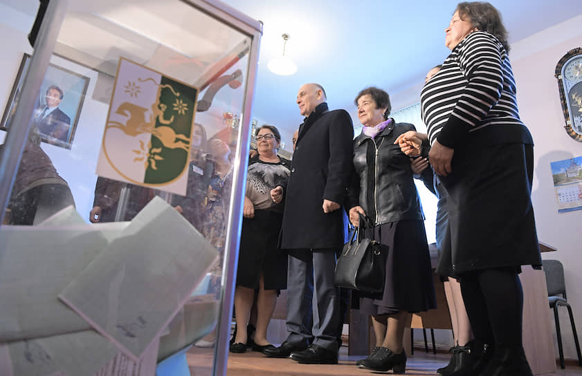 Кандидат в президенты Абхазии Аслан Бжания (третий справа) на избирательном участке