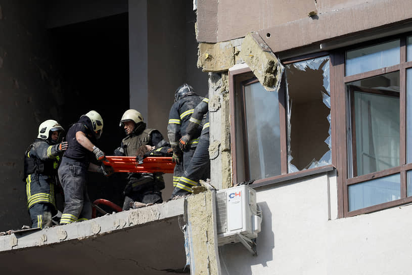 Сотрудники экстренных служб в Киеве эвакуируют человека из жилого дома, пострадавшего в результате ракетного удара