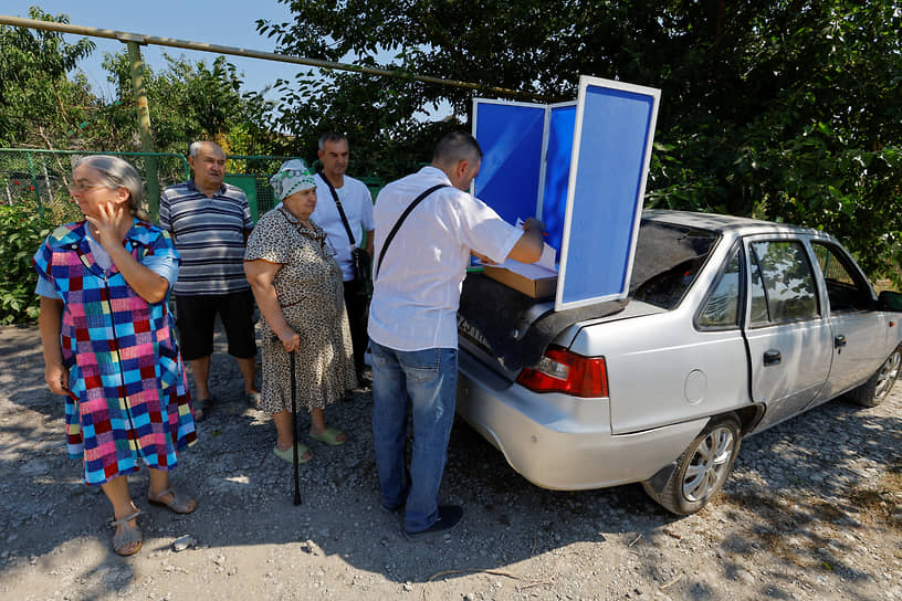 Жители Мариуполя стоят за бюллетенями на передвижном избирательном участке для голосования на досрочных выборах депутатов Народного совета ДНР
