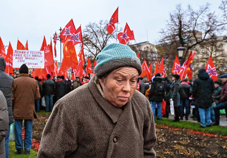 Москва. Женщина проходит мимо митинга на Театральной площади, приуроченного 105-й годовщине Октябрьской социалистической революции