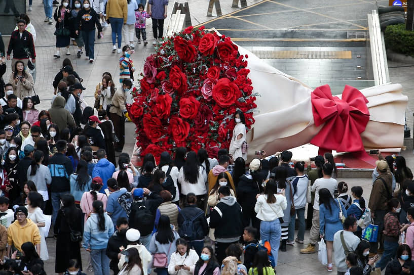Куньмин, Китай. Желающие сфотографироваться у праздничного украшения города — огромного букета роз