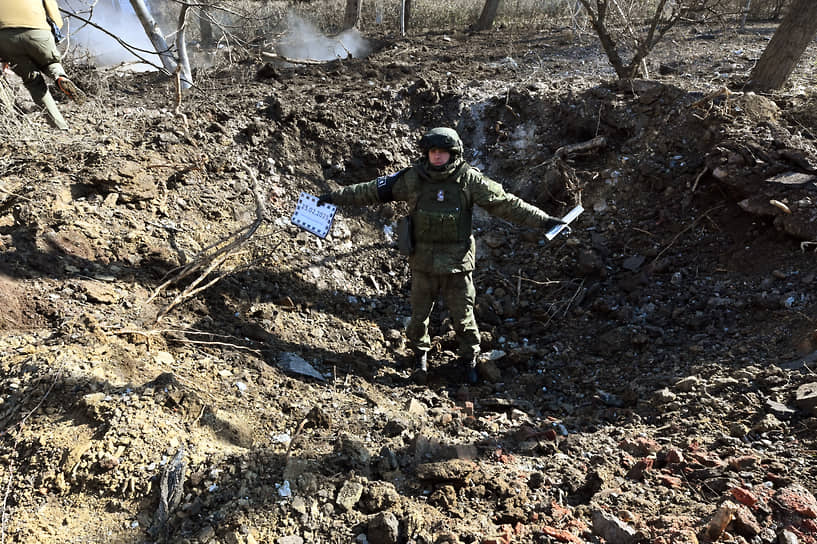 ДНР. Сотрудник Совместного центра контроля и координации в воронке, образовавшейся после падения снаряда в одном из районов Донецка