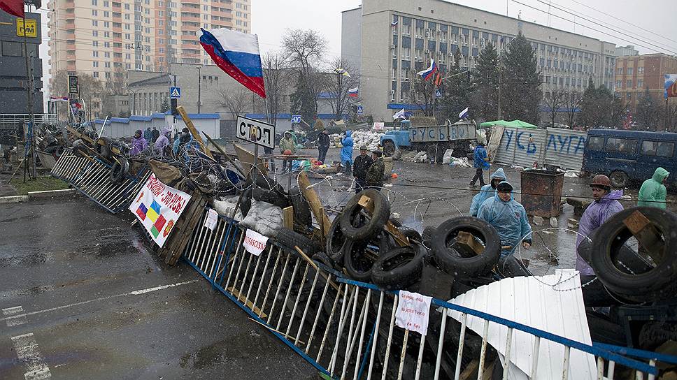 Митингующие в восточных регионах Украины, несмотря на обещания Киева, не спешат покидать захваченные ими помещения (на фото — баррикады у здания СБУ в Луганске) 