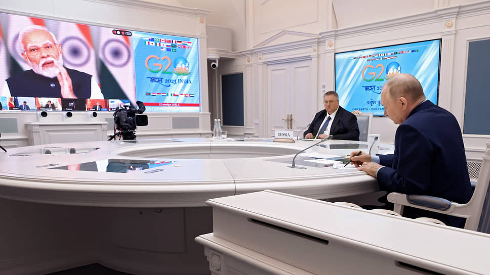 Владимир Путин поддержал премьера Индии Нарендру Моди (на экране) в его стремлении деполитизировать работу «двадцатки» и в то же время напомнил о потрясениях, вызванных «кровавым переворотом на Украине и истреблением гражданского населения в Палестине» 