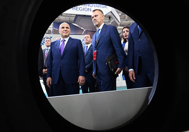 Антон Атрашкин (в центре) и Михаил Мишустин (слева) во время осмотра выставки.