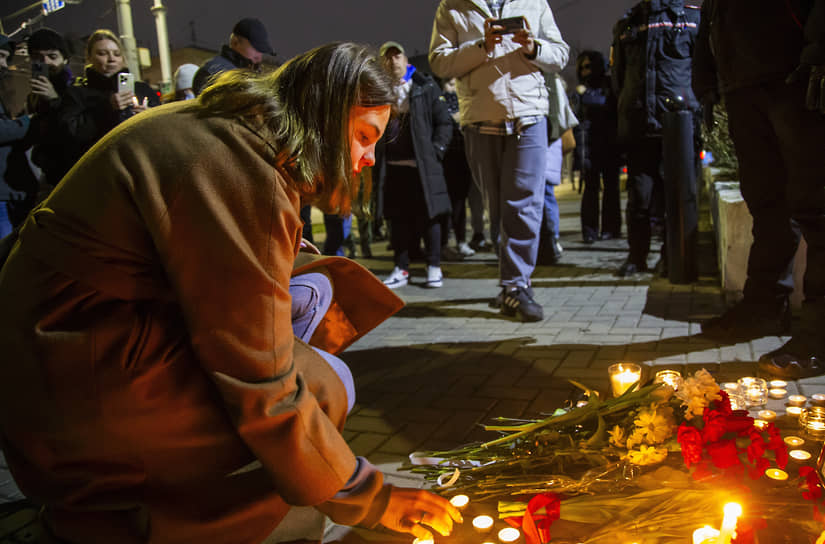 Девушка зажигает свечу у посольства России в Кишиневе (Молдавия)