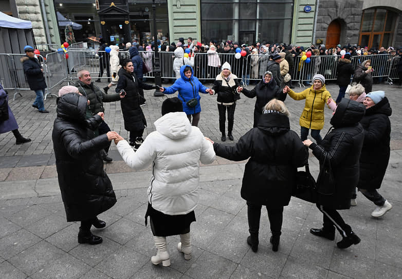 Хоровод на Кузнецком мосту в Москве на фоне очереди в посольство Молдовы