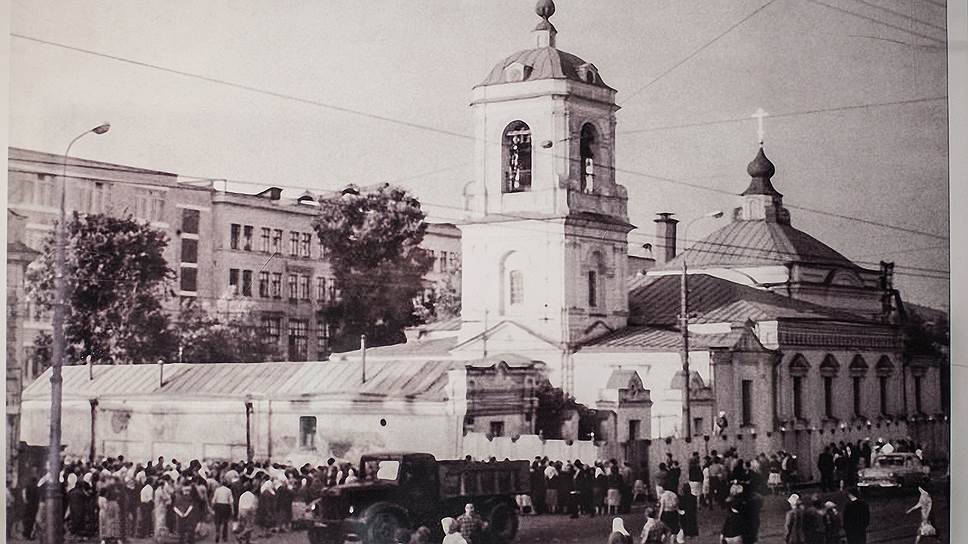 Фотография Преображенской площади перед сносом храма в июле 1964-го. Видны забор, которым его огородили перед взрывом, и верующие, окружившие храм 
