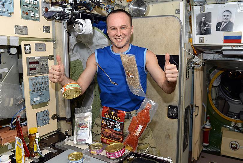 Космонавт Сергей Рязанский с традиционной космической едой: здесь и закуски, и суп, и второе блюдо, и даже компот с десертом