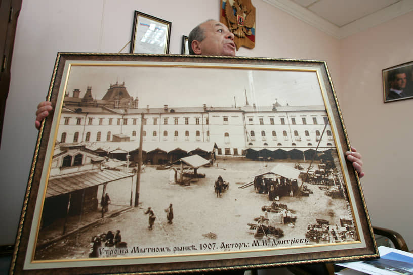 Собственник Мытного рынка Ваган Багдасарян с фотографией Максима Дмитриева, на которой изображен Мытный рынок 1907 года