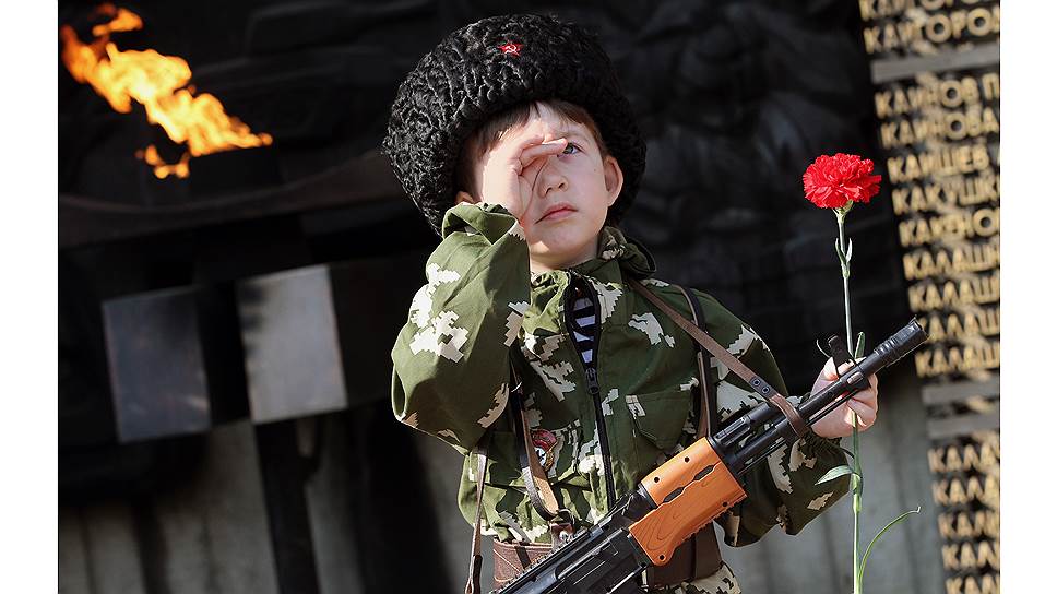 Мальчик в военной форме возле Монумента славы на площади Победы в Барнауле