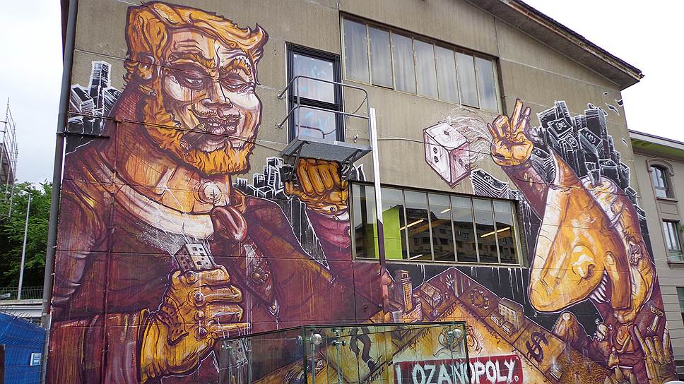Граффити, обнажающее язвы капитализма, на стене склада в районе Flon в Лозанне