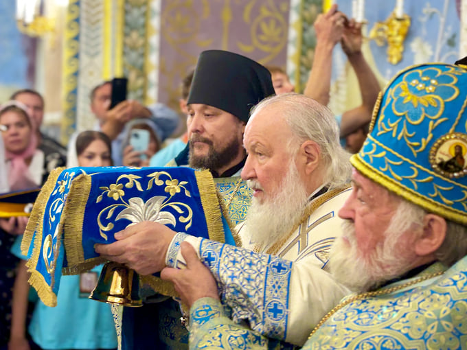 Патриарх Кирилл несет чашу для причастия