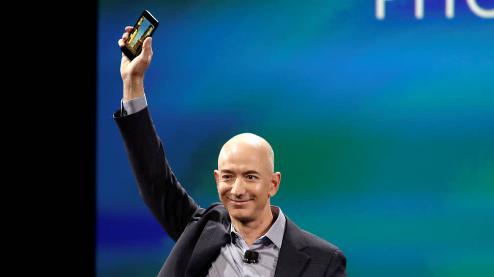Генеральный директор Amazon Джефф Безос со смартфоном Fire Phone, несостоявшимся убийцей iPhone 