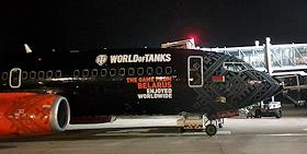 Национальный аэропорт 'Минск', самолёт Embraer авиакомпании Белавиа, раскрашенный в стиле компьютерной ММО-игры о бронетехнике World of Tanks , разработанной в Белоруссии, готовится к ночному вылету