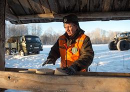 Genre photos. Views of the Novosibirsk region. Gamekeepers of the Ministry of Natural Resources and Ecology of the Novosibirsk Region during the arrangement of fodder fields, laying hay and salt to save and maintain the number of wild animals in the winter in the Tsentralny state nature reserve, Kolyvansky District, Novosibirsk Region