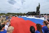 Members of the United Russia party unfurled the Russian State Flag in the Lenin Komsomol Park near the memorial 'To Your Liberators, Donbass!'. A motor rally