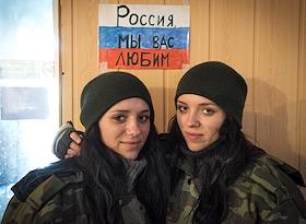 Подборка. Жанровое фото. В расположении отряда ДНР в районе деревни Луково (линия фронта недалеко от Мариуполя). Две сестры-близнецы Анна и Екатерина в расположении отряда ДНР в районе деревни Луково (линия фронта недалеко от Мариуполя). Боец ДНР показывает сваленные в кучу государственные флаги Украины, которые, по её словам, 'трофейные, привезены из Дебальцево'. 
Расположение отряда ДНР в деревне Луково.
